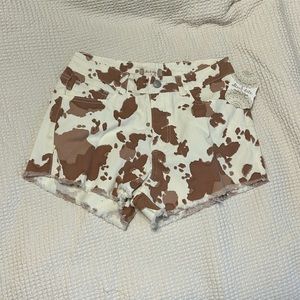 Altar’d State Cow Print Denim Shorts